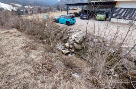 Spodkopano in poškodovano kamnito zavarovanje ob parkirišču ob stanovanjski hiši – odsek B  dolvodno od P10